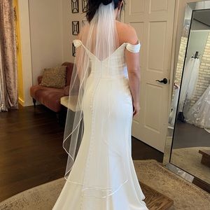 Ivory satin trimmed wedding veil.